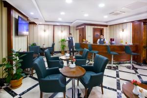 two men in a waiting room with blue chairs at Alpinn Hotel Istanbul in Istanbul
