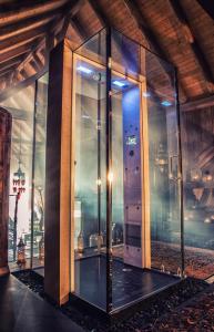 an elevator in a building with glass walls at Bijou Hotel / Love and Romance in Kallnach