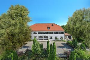 un gran edificio blanco con techo rojo en Brauereigasthof Hofmark, en Lenting