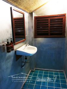 a bathroom with a sink and a blue tiled floor at Villa De Pai in Pai