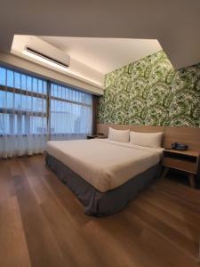 a bedroom with a large bed and a large window at Infinity Tower Suites in Manila