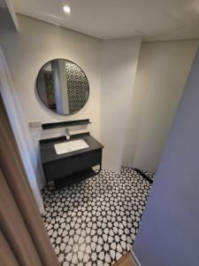 a bathroom with a sink and a mirror at Infinity Tower Suites in Manila