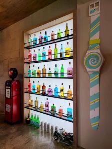 una parete piena di bottiglie di colore diverso di Tipsy Snail a Sanxing