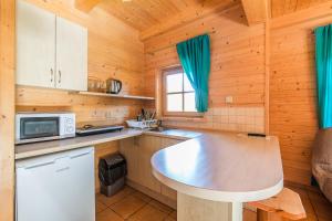 a kitchen with a counter top in a wooden cabin at Domki Bystre in Baligród