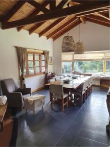 a dining room with a table and chairs at Casa privada amplia y tranquila, rodeada de naturaleza. in Lago Puelo