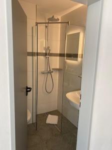 a bathroom with a shower and a sink at Hotel im Homburger Ländchen in Nümbrecht