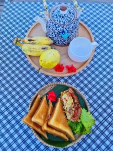 um prato de comida numa mesa com torradas e bananas em La Villa Hortensia-Mondulkiri em Phumĭ Pu Pal
