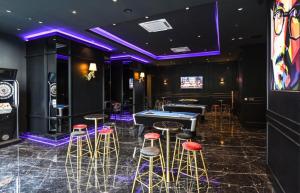 a room with a pool table and bar stools at Star Luxury Suites KLCC in Kuala Lumpur