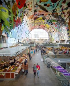 people walking through a market with a colorful ceiling at Thon Hotel Rotterdam City Centre in Rotterdam