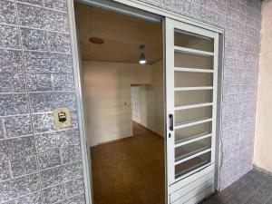 an empty room with a door and a hallway at Pousada Maranata in Bragança Paulista +6 photos