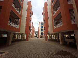 an empty street between two tall buildings at Mtwapa luxury Gold Star 3br in Kilifi