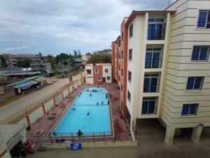 an overhead view of a swimming pool next to a building at Mtwapa luxury Gold Star 3br in Kilifi