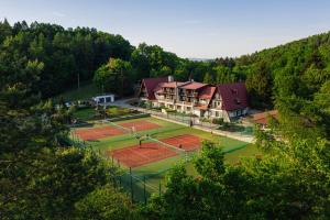 an aerial view of a tennis court with houses at Chata Cementár in Podhorie