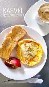 a white plate with eggs and toast and a cup of coffee at Hotel Kasvel in Valledupar