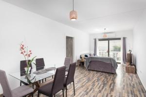 a living room with a table and chairs and a dining room at Happy Stay Apartment - Halefka Court in Larnaca
