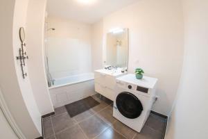 a bathroom with a washing machine and a sink at Paris & DisneyLand - 2min From Train Station - Free Private Parking in Villiers-sur-Marne +15 photos
