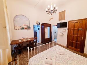a room with a bed and a table and a kitchen at Florence Signoria Apartment in Florence