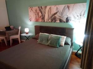 a bedroom with a bed with a painting on the wall at Centro Storico Suites Giovinazzo in Giovinazzo +128 photos