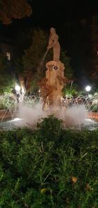 a water fountain in a park at night at Apartamentos Plaza,viviendas turisticas in Alicante