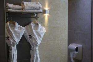 a bathroom with white shower nets and towels at Maryotel in Bishkek