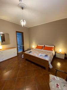 a bedroom with a bed with orange pillows on it at Villa Franca in Reggio di Calabria