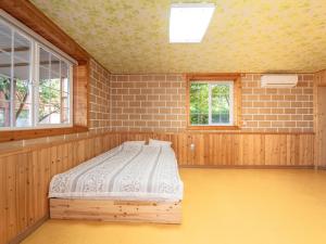 a bedroom with a bed in the middle of a room at Healing Camp Yesone in Gangneung