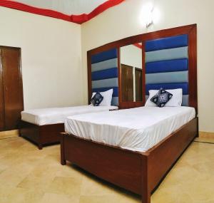 a bedroom with two beds in a room at SUBHAN PALACE Near Lasania Restaurant & Millennium Mall in Karachi