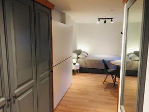 a room with a bedroom with a bed and a table at Mountain Apartment Gerlitzen in Kanzelhöhe