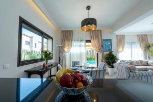 a living room with a bowl of fruit on a table at Villa Palmeraie Golf Agadir in Agadir