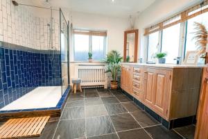 a bathroom with a shower and a bath tub at Spacious Sea-View Apt. Overlooking St Ives Bay in Gwithian