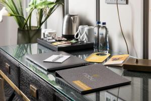 a glass desk with a laptop and a bottle on it at Nabu Hotel Karaköy in Istanbul