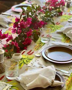 a table with a table cloth with flowers on it at Kilmorna Manor Guest House in Schoemanskloof