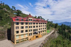 a building with a red roof on a mountain at Fortune Park Kufri, Shimla - Member ITC's Hotel Group in Shimla