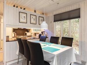 a kitchen and dining room with a table and chairs at 4 person holiday home in Hals in Hals