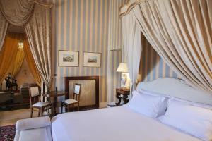 a bedroom with a large bed with a canopy at Palazzo Cherubini-Pools & Wellness in Rossano +101 photos