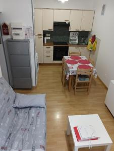 a kitchen with a couch and a table in a room at VILLA DUCHATEL in Le Mont-Dore