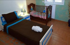 a bedroom with a large bed and a crib at Kosmira Big House in Ioannina
