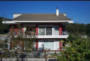 a house with a porch and a balcony at Kosmira Big House in Ioannina