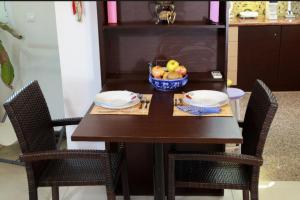 a wooden table with a bowl of fruit on it at Kosmira Big House in Ioannina