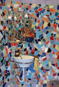 a bathroom with a sink and a mosaic wall at Kosmira Big House in Ioannina