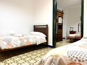 a bedroom with two beds and a mirror at Las maravillas de Manuel By Solymar Holiday in Málaga