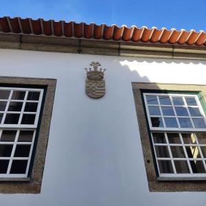 a building with a clock on the side of it at Casa de Santa Ana da Beira in Seia