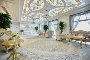 a large living room with a fancy ceiling at Royal Hotel Samarkand in Samarkand