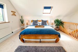 a bedroom with a large bed in a attic at Spacious Sea-View Apt. Overlooking St Ives Bay in Gwithian