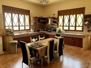 a kitchen with a table and chairs in a kitchen at Luxury villa with a pool for your family getaway in Marrakesh