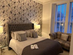 a bedroom with a bed with two shoes on it at No 9 retreat in Prestwick