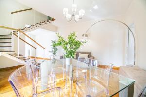 a dining room with a glass table and chairs at Penthouse in the heart of the city center in Rome