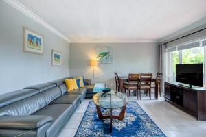 a living room with a couch and a table at Ocean Reef At Deerfield #4 in Deerfield Beach