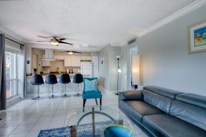 a living room with a couch and a kitchen at Ocean Reef At Deerfield #4 in Deerfield Beach