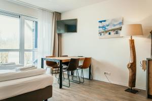 a hotel room with a desk and a bed at Hotel De Zeeuwse Kust (family only) in Renesse